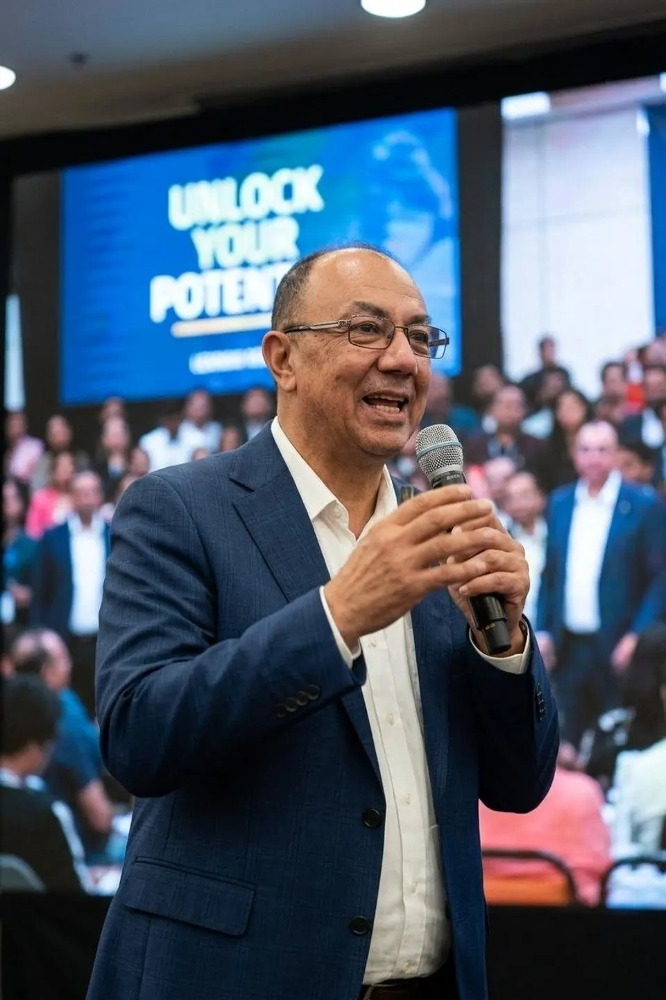 Alain Salomon speaking to an audience on stage